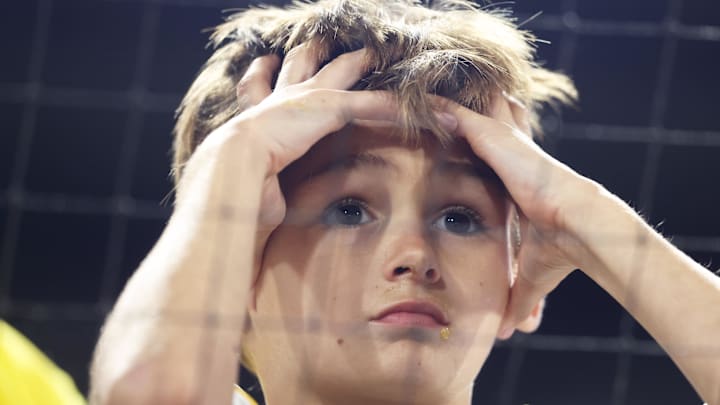Sep 15, 2025; Pittsburgh, Pennsylvania, USA;  A young Pittsburgh Pirates fan watches the game action against the Chicago Cubs during the sixth inning at PNC Park. Mandatory Credit: Charles LeClaire-Imagn Images