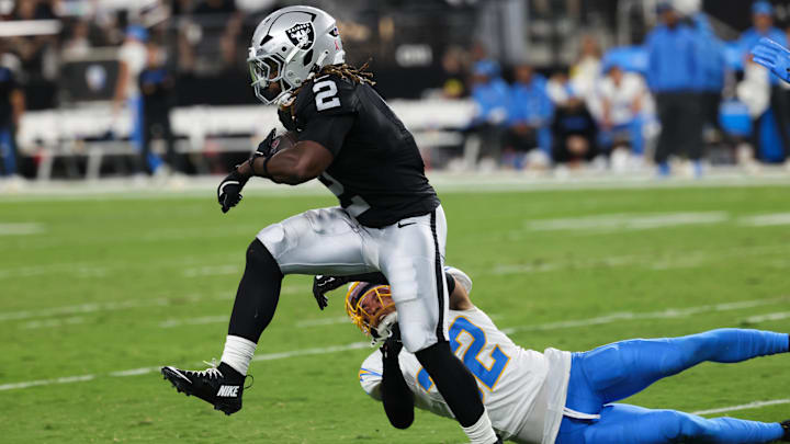 Sep 15, 2025; Paradise, Nevada, USA; Las Vegas Raiders running back Ashton Jeanty (2) evades a tackle from Los Angeles Chargers safety Alohi Gilman (32) during the first quarter at Allegiant Stadium. Mandatory Credit: Kiyoshi Mio-Imagn Images Sep 15, 2025; Paradise, Nevada, USA; Las Vegas Raiders running back Ashton Jeanty (2) evades a tackle from Los Angeles Chargers safety Alohi Gilman (32) during the first quarter at Allegiant Stadium. Mandatory Credit: Kiyoshi Mio-Imagn Images
