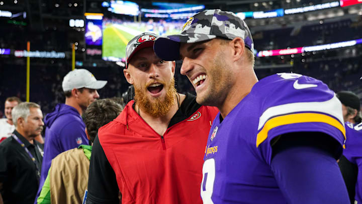 San Francisco 49ers tight end George Kittle (L) with Minnesota Vikings quarterback Kirk Cousins (R)