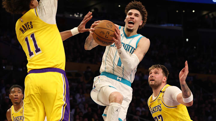 Feb 19, 2025; Los Angeles, California, USA; Charlotte Hornets guard LaMelo Ball (1) shoots against Los Angeles Lakers center Jaxson Hayes (11) and guard Luka Doncic (77) during the fourth quarter at Crypto.com Arena. Mandatory Credit: Jason Parkhurst-Imagn Images Feb 19, 2025; Los Angeles, California, USA; Charlotte Hornets guard LaMelo Ball (1) shoots against Los Angeles Lakers center Jaxson Hayes (11) and guard Luka Doncic (77) during the fourth quarter at Crypto.com Arena. Mandatory Credit: Jason Parkhurst-Imagn Images
