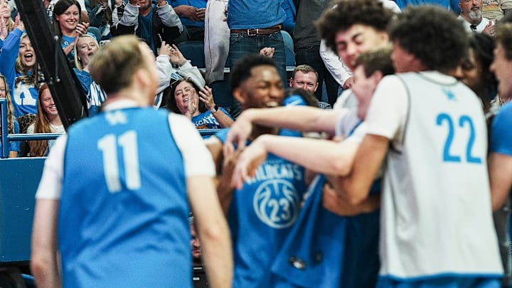 Kentucky fans cheer as the Wildcats crowd around forward Trent Noah (9) after his three-point shooting display at the 2025 Big Blue Madness at Rupp Arena in Lexington, Kentucky Saturday, Oct. 11, 2025.