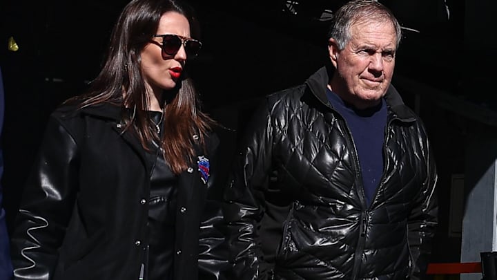 Former New England Patriots head coach Bill Belichick and girlfriend Jordon Hudson enter the field before the game between the Notre Dame Fighting Irish and the Navy Midshipmen at MetLife Stadium.