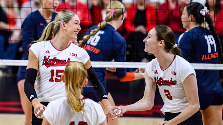 Andi Jackson smiles at Bergen Reilly after scoring a point against Illinois. Jackson and Reilly's connected helped them power Nebraska's elite offense. 