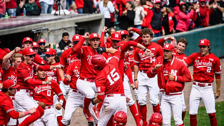 Dylan Carey (15) celebrates his solo homerun with the Husker dugout. Dylan Carey (15) celebrates his solo homerun with the Husker dugout.
