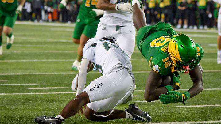 Oregon tight end Kendre Harrison, right, dives over Portland State safety Dionte West for a touchdown as the Oregon Ducks host the Portland State Vikings on Sept. 18, 2026, at Autzen Stadium in Eugene, Oregon.