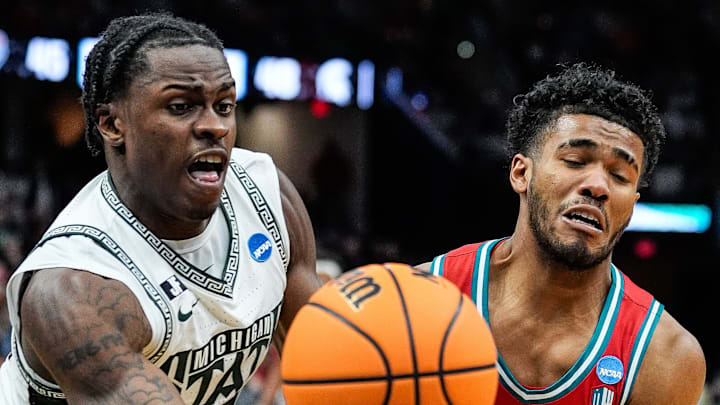Michigan State forward Coen Carr (55) and New Mexico guard Donovan Dent (2) battle for the ball during the second half of the Second Round of NCAA tournament at Rocket Arena in Cleveland, Ohio on Sunday, March 23, 2025.