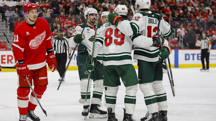 Feb 22, 2025; Detroit, Michigan, USA; The Minnesota Wild celebrate a goal scored in the third period at Little Caesars Arena. Mandatory Credit: Brian Bradshaw Sevald-Imagn Images