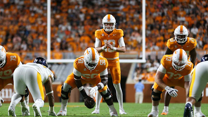 Sep 14, 2024; Knoxville, Tennessee, USA; Tennessee Volunteers quarterback Gaston Moore (13) receives a snap from offensive lineman William Satterwhite (50) during the game against the Kent State Golden Flashes at Neyland Stadium. Mandatory Credit: Randy Sartin-Imagn Images