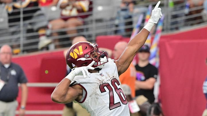 Sep 29, 2024; Glendale, Arizona, USA;  Washington Commanders running back Jeremy McNichols (26) scores a touchdown in the second half against the Arizona Cardinals at State Farm Stadium. Mandatory Credit: Matt Kartozian-Imagn Images