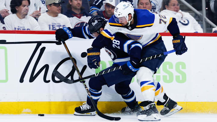 Apr 30, 2025; Winnipeg, Manitoba, CAN; St. Louis Blues defenseman Justin Faulk (72) checks Winnipeg Jets forward Jaret Anderson-Dolan (28) during the second period in game five of the first round of the 2025 Stanley Cup Playoffs at Canada Life Centre. Mandatory Credit: Terrence Lee-Imagn Images