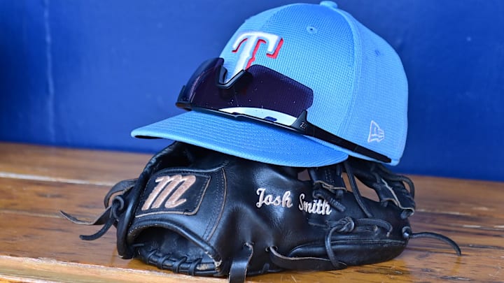 Mar 15, 2024; Salt River Pima-Maricopa, Arizona, USA; General view of a Texas Rangers hat, glove, and glasses prior to a spring training game against the Colorado Rockies at Salt River Fields at Talking Stick. Mar 15, 2024; Salt River Pima-Maricopa, Arizona, USA; General view of a Texas Rangers hat, glove, and glasses prior to a spring training game against the Colorado Rockies at Salt River Fields at Talking Stick.