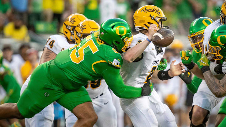 Oregon Ducks defensive lineman Derrick Harmon forces a fumble from Idaho Vandals quarterback Jack Layne as the Oregon Ducks host the Idaho Vandals Saturday, Aug. 31, 2024, at Autzen Stadium in Eugene, Ore. Oregon Ducks defensive lineman Derrick Harmon forces a fumble from Idaho Vandals quarterback Jack Layne as the Oregon Ducks host the Idaho Vandals Saturday, Aug. 31, 2024, at Autzen Stadium in Eugene, Ore.
