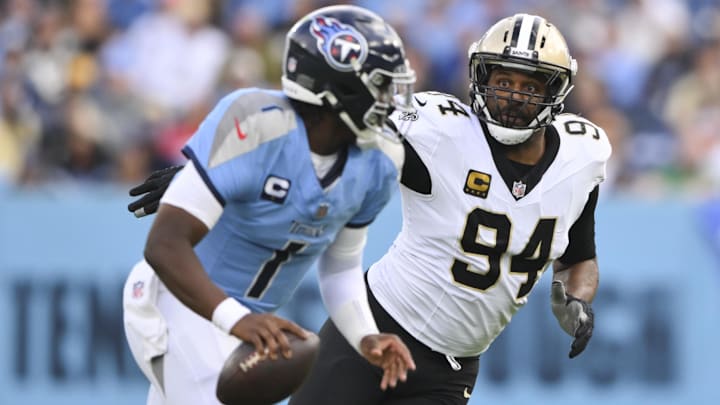 Dec 28, 2025; Nashville, Tennessee, USA;  New Orleans Saints defensive end Cameron Jordan (94) gives chase to Tennessee Titans quarterback Cam Ward (1) during the second half of the game at Nissan Stadium. Mandatory Credit: Steve Roberts-Imagn Images