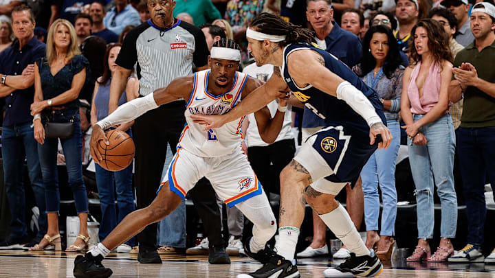 Oklahoma City Thunder guard Shai Gilgeous-Alexander controls the ball as Denver Nuggets forward Aaron Gordon guards. Oklahoma City Thunder guard Shai Gilgeous-Alexander controls the ball as Denver Nuggets forward Aaron Gordon guards.