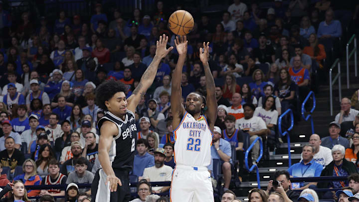 Dec 25, 2025; Oklahoma City, Oklahoma, USA; Oklahoma City Thunder guard Cason Wallace (22) shoots as San Antonio Spurs guard Dylan Harper (2) defends during the second half at Paycom Center. Mandatory Credit: Alonzo Adams-Imagn Images