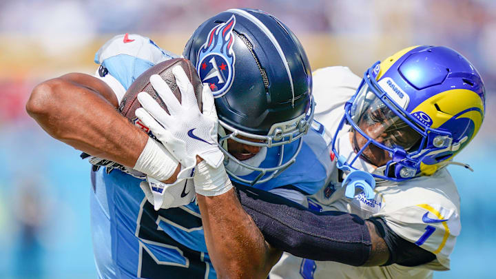 Tennessee Titans wide receiver Elic Ayomanor (5) catches the ball over tight coverage from Los Angeles Rams cornerback Emmanuel Forbes Jr. (1) during the second quarter at Nissan Stadium in Nashville, Tenn., Sunday, Sept. 14, 2025.