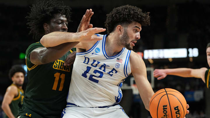 Duke Blue Devils forward Cameron Boozer grabs a rebound against Siena Saints forward Francis Folefac.