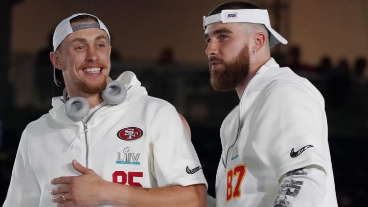 Jan 27, 2020; Miami, FL, USA;  San Francisco 49ers tight end George Kittle (85) greets Kansas City Chiefs tight end Travis Kelce (87) during Super Bowl LIV Opening Night at Marlins Park.  Mandatory Credit: Kirby Lee-USA TODAY Sports
