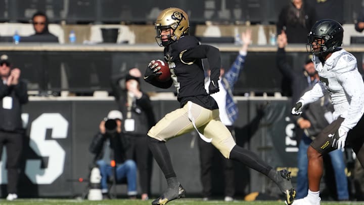 Nov 5, 2022; Boulder, Colorado, USA; Colorado Buffaloes wide receiver Jordyn Tyson (4) carries the ball for a touchdown past Oregon Ducks defensive back Steve Stephens IV (7) the second quarter at Folsom Field. Mandatory Credit: Ron Chenoy-Imagn Images