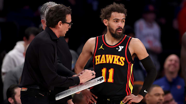 Atlanta Hawks head coach Quin Snyder talks with Trae Young during a game against the New York Knicks.