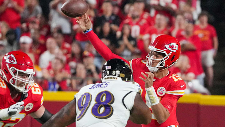Sep 5, 2024; Kansas City, Missouri, USA; Kansas City Chiefs quarterback Patrick Mahomes (15) throws a pass as Baltimore Ravens defensive tackle Travis Jones (98) defends during the first half at GEHA Field at Arrowhead Stadium. Mandatory Credit: Denny Medley-Imagn Images