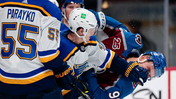 Jan 13, 2021; Denver, Colorado, USA; St. Louis Blues defenseman Torey Krug (47) pushes Colorado Avalanche right wing Mikko Rantanen (96) as defenseman Colton Parayko (55) looks on in the third period at Ball Arena. Mandatory Credit: Isaiah J. Downing-Imagn Images