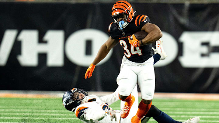 Denver Broncos cornerback Riley Moss (21) tackles Cincinnati Bengals halfback Khalil Herbert (34) in the overtime of the NFL game at Paycor Stadium in Cincinnati on Saturday, Dec. 28, 2024. Denver Broncos cornerback Riley Moss (21) tackles Cincinnati Bengals halfback Khalil Herbert (34) in the overtime of the NFL game at Paycor Stadium in Cincinnati on Saturday, Dec. 28, 2024.