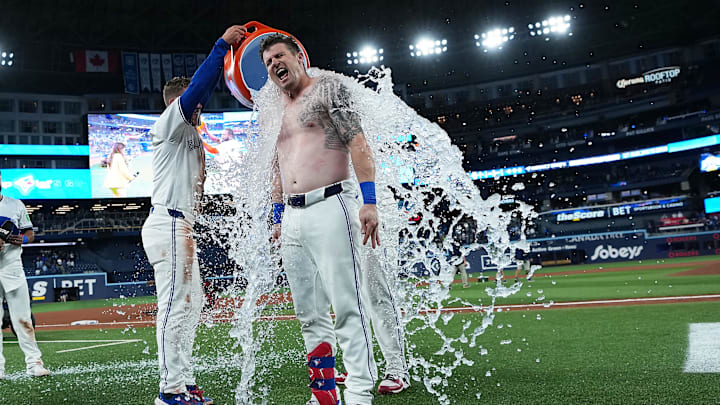 Toronto Blue Jays catcher Tyler Heineman (55) gets the water bucket poured on him against the Houston Astros at then of the tenth  inning at Rogers Centre. 