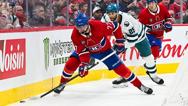 Oct 20, 2026; Montreal, Quebec, CAN;  Montreal Canadiens center Kirby Dach (77) plays the puck against San Jose Sharks defenseman Darnell Nurse (25) during the second period at Bell Centre.  Mandatory Credit: David Kirouac-Imagn Images