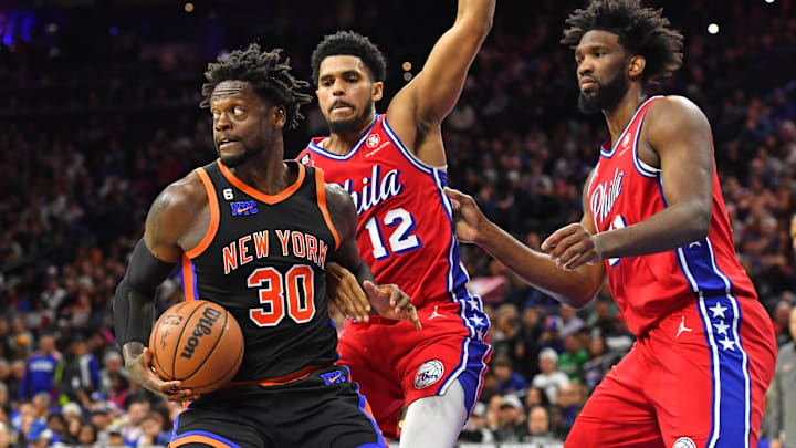 Feb 10, 2023; Philadelphia, Pennsylvania, USA; New York Knicks forward Julius Randle (30) grabs rebound against Philadelphia 76ers forward Tobias Harris (12) and center Joel Embiid (21) during the second quarter at Wells Fargo Center. Mandatory Credit: Eric Hartline-Imagn Images