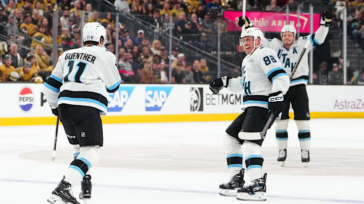 Apr 21, 2026; Las Vegas, Nevada, USA; Utah Mammoth right wing Dylan Guenther (11) celebrates with defenseman Nate Schmidt (88) and defenseman Mikhail Sergachev (98) after scoring a goal against the Vegas Golden Knights during the second period of game two of the first round of the 2026 Stanley Cup Playoffs at T-Mobile Arena. Mandatory Credit: Stephen R. Sylvanie-Imagn Images