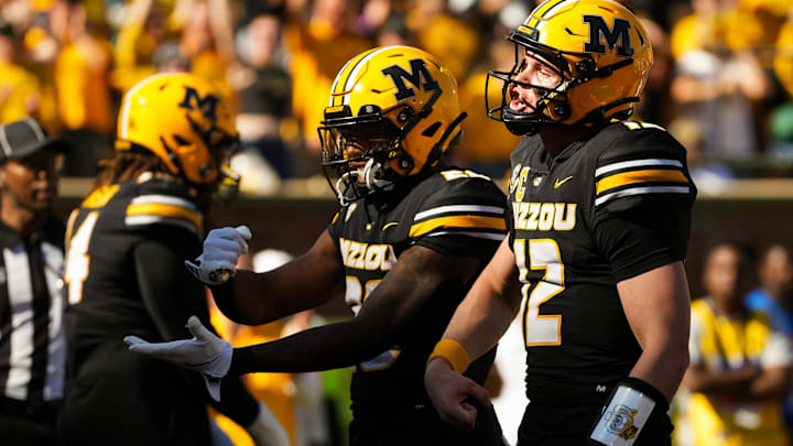 Oct 19, 2024; Columbia, Missouri, USA; Missouri Tigers quarterback Brady Cook (12) celebrates with teammates after converting a two-point conversion during the second half against the Auburn Tigers at Faurot Field at Memorial Stadium. Mandatory Credit: Jay Biggerstaff-Imagn Images Oct 19, 2024; Columbia, Missouri, USA; Missouri Tigers quarterback Brady Cook (12) celebrates with teammates after converting a two-point conversion during the second half against the Auburn Tigers at Faurot Field at Memorial Stadium. Mandatory Credit: Jay Biggerstaff-Imagn Images