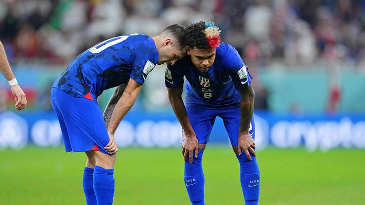 Nov 29, 2022; Doha, Qatar; United States of America forward Christian Pulisic (10) leans his head on midfielder Weston McKennie (8) after sustaining an injury after colliding with Iran goalkeeper Alireza Beiranvand (not pictured) following his goal during the first half of a group stage match during the 2022 World Cup at Al Thumama Stadium. Mandatory Credit: Danielle Parhizkaran-Imagn Images