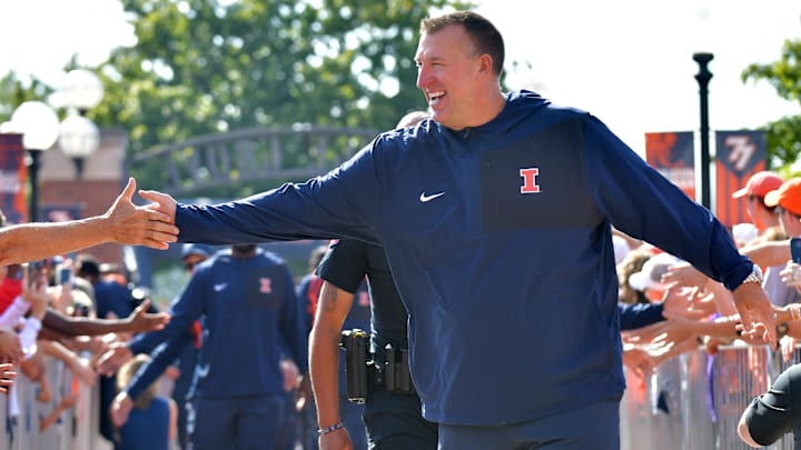 Aug 29, 2025; Champaign, Illinois, USA;  Illinois Fighting Illini head coach Bret Bielema leads his team during the Illini Walk before an NCAA football game against the Western Illinois Leathernecks at Memorial Stadium. Mandatory Credit: Ron Johnson-Imagn Images