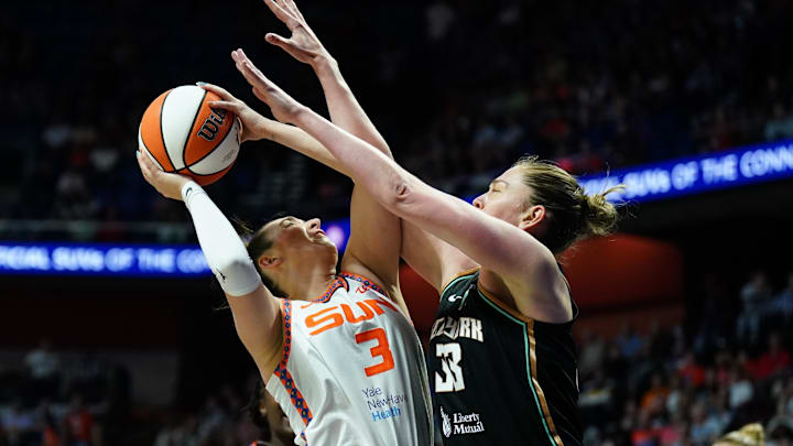 Aug 3, 2025; Uncasville, Connecticut, USA; New York Liberty forward Emma Meesseman (33) defends against Connecticut Sun guard Marina Mabrey (3) in the first half at Mohegan Sun Arena. Mandatory Credit: David Butler II-Imagn Images