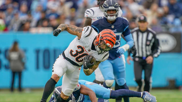 Cincinnati Bengals running back Chase Brown (30) is stopped by Tennessee Titans cornerback Daryl Worley (35) during the first quarter at Nissan Stadium in Nashville, Tenn., Sunday, Dec. 15, 2024.