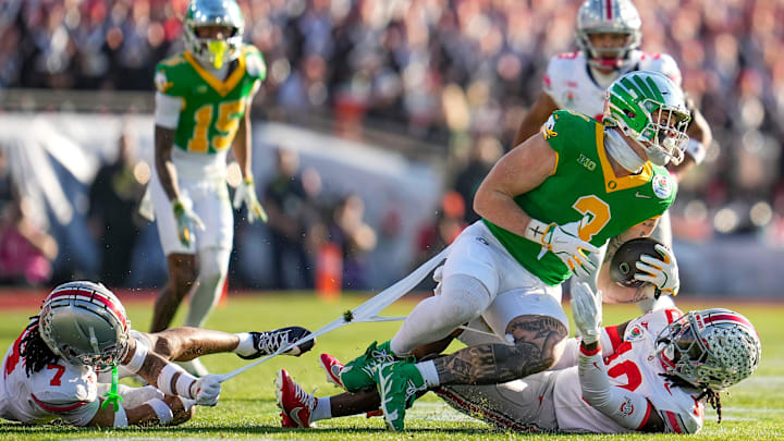 Ohio State Buckeyes cornerback Jordan Hancock (7) and cornerback Denzel Burke (10) bring down Oregon Ducks tight end Terrance Ferguson (3) during the first half of the College Football Playoff quarterfinal at the Rose Bowl in Pasadena, Calif. on Jan. 1, 2025. Ohio State Buckeyes cornerback Jordan Hancock (7) and cornerback Denzel Burke (10) bring down Oregon Ducks tight end Terrance Ferguson (3) during the first half of the College Football Playoff quarterfinal at the Rose Bowl in Pasadena, Calif. on Jan. 1, 2025.