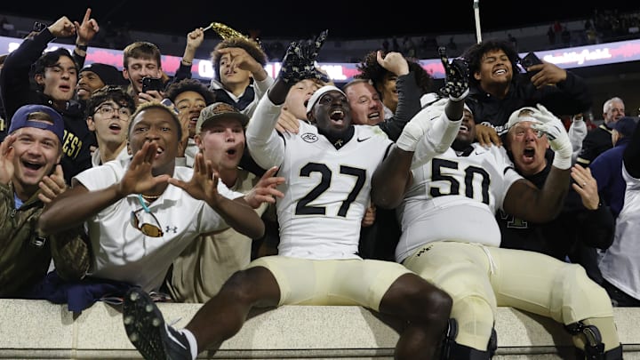 Nov 8, 2025; Charlottesville, Virginia, USA; Wake Forest Demon Deacons players celebrates with fans in the stands after defeating the Virginia Cavaliers at Scott Stadium. Mandatory Credit: Amber Searls-Imagn Images