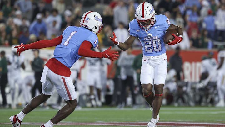 Nov 23, 2024; Houston, Texas, USA; Houston Cougars defensive back Jeremiah Wilson (20) celebrates with defensive back Latrell McCutchin Sr. (1) after an interception during the first quarter against the Baylor Bears at TDECU Stadium. Mandatory Credit: Troy Taormina-Imagn Images