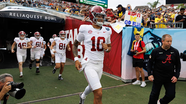 Dec 31, 2024; Tampa, FL, USA; Alabama Crimson Tide quarterback Austin Mack (10) runs onto the field before a game against the Michigan Wolverines at Raymond James Stadium. Mandatory Credit: Matt Pendleton-Imagn Images