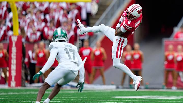Sep 19, 2026; Madison, Wisconsin, USA;  Wisconsin Badgers wide receiver Tyrell Henry (0) catches a pass in front of Eastern Michigan Eagles defensive back Caleb Dobbs (17) during the second quarter at Camp Randall Stadium. Mandatory Credit: Jeff Hanisch-Imagn Images