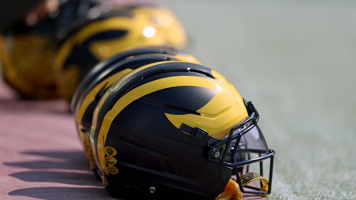 Sep 6, 2025; Norman, Oklahoma, USA; Michigan Wolverine helmets sit on the field near the sideline prior to a game against the Oklahoma Sooners at Gaylord Family-Oklahoma Memorial Stadium. Mandatory Credit: Kevin Jairaj-Imagn Images Sep 6, 2025; Norman, Oklahoma, USA; Michigan Wolverine helmets sit on the field near the sideline prior to a game against the Oklahoma Sooners at Gaylord Family-Oklahoma Memorial Stadium. Mandatory Credit: Kevin Jairaj-Imagn Images