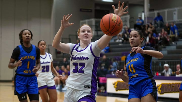 Johnston’s Paige Andernacht (32) reaches for a loose ball against Davenport North during a girls basketball game on Dec. 21, 2024, at the Johnston Winter Tipoff at Johnston High School in Johnston. Mandatory Credit: Bryon Houlgrave-The Des Moines Register