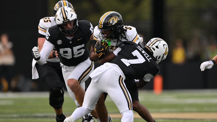 Oct 25, 2025; Nashville, Tennessee, USA; Missouri Tigers wide receiver Joshua Manning (0) is tackled by Vanderbilt Commodores safety Marlen Sewell (7) during the third quarter at FirstBank Stadium. Mandatory Credit: Steve Roberts-Imagn Images Oct 25, 2025; Nashville, Tennessee, USA; Missouri Tigers wide receiver Joshua Manning (0) is tackled by Vanderbilt Commodores safety Marlen Sewell (7) during the third quarter at FirstBank Stadium. Mandatory Credit: Steve Roberts-Imagn Images