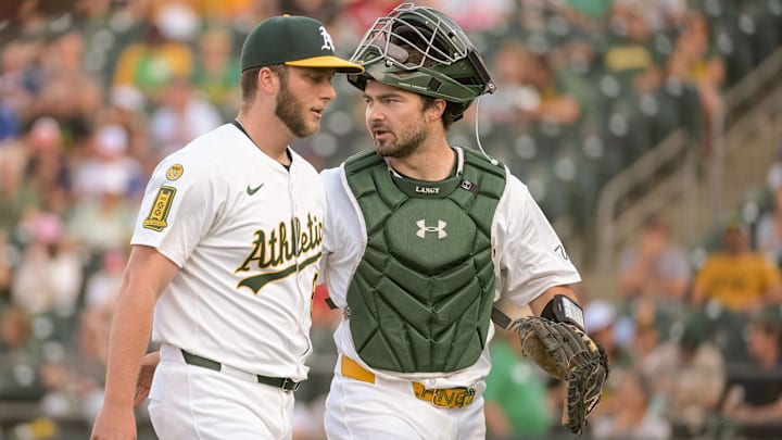 Jun 4, 2025; West Sacramento, California, USA; Athletics pitcher Justin Sterner (60) talks with catcher Shea Langeliers (23) at the end of the first inning in the game against the Minnesota Twins at Sutter Health Park. Mandatory Credit: Ed Szczepanski-Imagn Images Jun 4, 2025; West Sacramento, California, USA; Athletics pitcher Justin Sterner (60) talks with catcher Shea Langeliers (23) at the end of the first inning in the game against the Minnesota Twins at Sutter Health Park. Mandatory Credit: Ed Szczepanski-Imagn Images