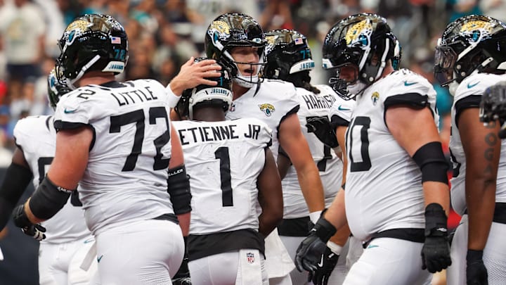 Nov 9, 2025; Houston, Texas, USA; Jacksonville Jaguars running back Travis Etienne Jr. (1) is hugged by quarterback Trevor Lawrence (16) after scoring a touchdown against the Houston Texans during the second half at NRG Stadium. Mandatory Credit: Thomas Shea-Imagn Images Nov 9, 2025; Houston, Texas, USA; Jacksonville Jaguars running back Travis Etienne Jr. (1) is hugged by quarterback Trevor Lawrence (16) after scoring a touchdown against the Houston Texans during the second half at NRG Stadium. Mandatory Credit: Thomas Shea-Imagn Images