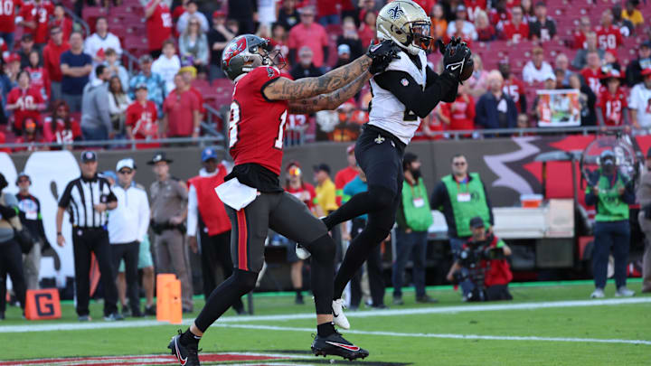 New Orleans Saints cornerback Paulson Adebo (29) intercepts a pass to Tampa Bay Buccaneers wide receiver Mike Evans (13) New Orleans Saints cornerback Paulson Adebo (29) intercepts a pass to Tampa Bay Buccaneers wide receiver Mike Evans (13)