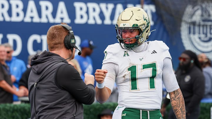 Memphis, Tennessee, USA; South Florida Bulls quarterback Byrum Brown (17) and head coach Alex Goulash (obscured) shake hands during the second quarter against the Memphis Tigers at Simmons Bank Liberty Stadium.