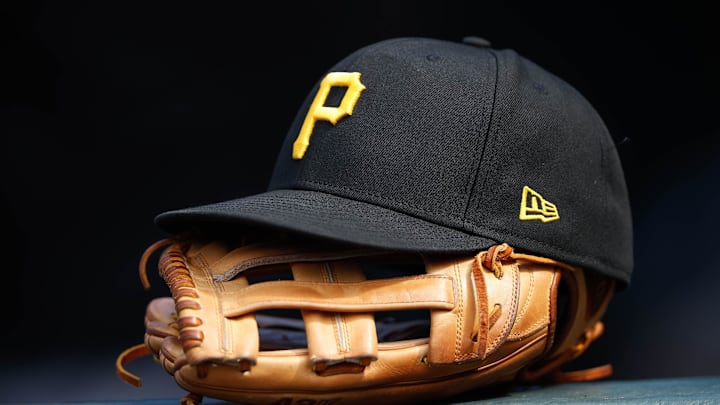 Jun 30, 2021; Denver, Colorado, USA; A general view of a Pittsburgh Pirates glove and hat in the eighth inning against the Colorado Rockies at Coors Field. Mandatory Credit: Isaiah J. Downing-Imagn Images