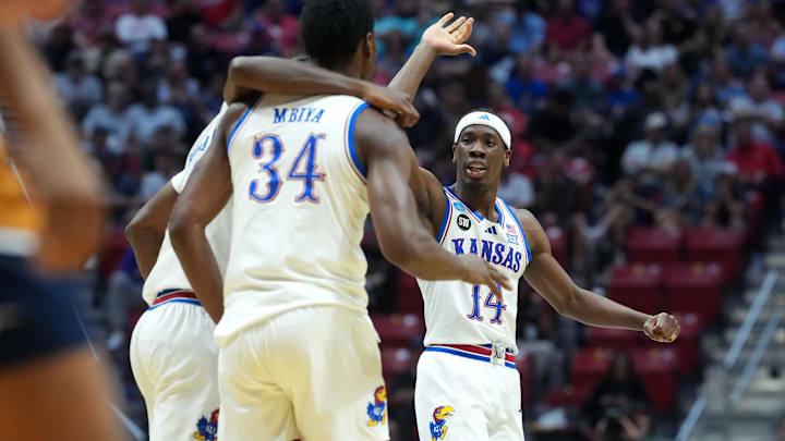 Mar 20, 2026; San Diego, CA, USA; Kansas Jayhawks guard Melvin Council Jr. (14) and center Paul Mbiya (34) react in the first half against the California Baptist Lancers during a first round game of the men's 2026 NCAA Tournament at Viejas Arena. Mandatory Credit: Kirby Lee-Imagn Images Mar 20, 2026; San Diego, CA, USA; Kansas Jayhawks guard Melvin Council Jr. (14) and center Paul Mbiya (34) react in the first half against the California Baptist Lancers during a first round game of the men's 2026 NCAA Tournament at Viejas Arena. Mandatory Credit: Kirby Lee-Imagn Images